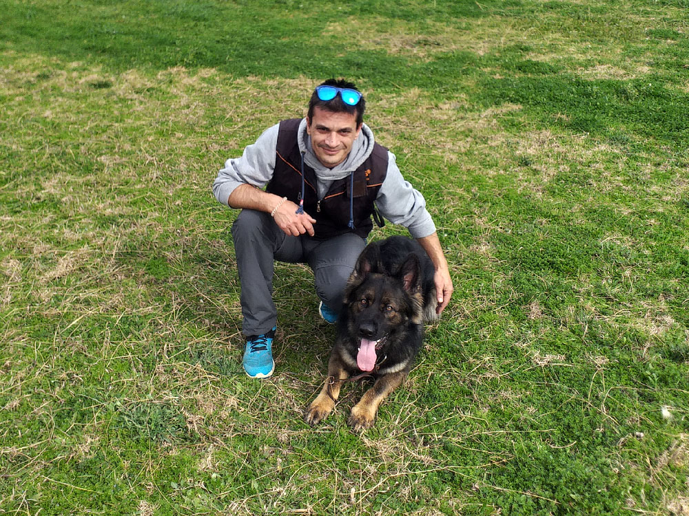 a dog and a man sitting